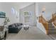 Bright living room featuring soaring ceilings, large windows, and a staircase with wood banister at 285 W Goldfinch Way, Chandler, AZ 85286