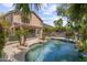 Backyard pool surrounded by lush greenery and lounge areas at 285 W Goldfinch Way, Chandler, AZ 85286