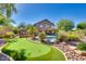 Beautiful backyard featuring a putting green, swimming pool, and lush landscaping for outdoor enjoyment at 29023 N 46Th Way, Cave Creek, AZ 85331