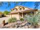 Inviting home featuring a three-car garage, desert landscaping, and a tile roof at 29023 N 46Th Way, Cave Creek, AZ 85331
