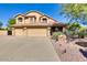 Inviting home featuring a three-car garage, desert landscaping, and a tile roof at 29023 N 46Th Way, Cave Creek, AZ 85331