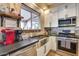 Updated kitchen with stainless steel appliances, apron sink, and a window that brings in natural light at 29023 N 46Th Way, Cave Creek, AZ 85331