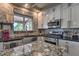 Modern kitchen with stainless steel appliances, stone backsplash, and an island perfect for entertaining at 29023 N 46Th Way, Cave Creek, AZ 85331