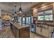 Open concept kitchen with granite island, stainless steel appliances, and views into the living area at 29023 N 46Th Way, Cave Creek, AZ 85331
