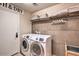 Convenient laundry room with a modern washer and dryer and built-in storage shelves at 29023 N 46Th Way, Cave Creek, AZ 85331