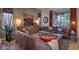 Spacious living room featuring leather sofas, a large window, and tasteful decor at 29023 N 46Th Way, Cave Creek, AZ 85331