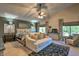 Spacious main bedroom with vaulted ceiling, ceiling fan and comfortable seating area at 29023 N 46Th Way, Cave Creek, AZ 85331