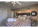Cozy bedroom featuring a queen bed with decorative pillows and overhead lighting at 29023 N 46Th Way, Cave Creek, AZ 85331