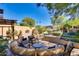 Outdoor patio with comfortable seating, lush landscaping, and a peaceful ambiance at 29023 N 46Th Way, Cave Creek, AZ 85331