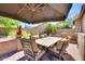 Charming outdoor patio area with a dining table, seating, and landscaped surroundings at 29023 N 46Th Way, Cave Creek, AZ 85331