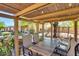 Covered patio featuring a dining table, seating, and a charming outdoor living space at 29023 N 46Th Way, Cave Creek, AZ 85331