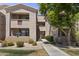 Exterior view of a tan-colored building with balconies and lush green landscaping at 29606 N Tatum Blvd # 174, Cave Creek, AZ 85331