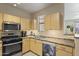 Bright kitchen with stainless appliances, double basin sink, and light wood cabinetry at 29606 N Tatum Blvd # 174, Cave Creek, AZ 85331