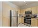 Well-lit kitchen features stainless steel appliances and light wood cabinetry at 29606 N Tatum Blvd # 174, Cave Creek, AZ 85331