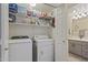 Functional laundry room with washer, dryer, and organized shelving at 29606 N Tatum Blvd # 174, Cave Creek, AZ 85331
