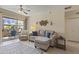 Comfortable living room with neutral-toned sofa, ceiling fan, and balcony access at 29606 N Tatum Blvd # 174, Cave Creek, AZ 85331
