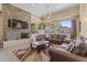 A brightly lit living room is equipped with a stone fireplace, comfortable leather sofas, and a stylish rug at 29606 N Tatum Blvd # 174, Cave Creek, AZ 85331