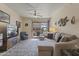 Well-lit living room featuring a ceiling fan, comfortable seating, and balcony views at 29606 N Tatum Blvd # 174, Cave Creek, AZ 85331