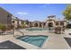 Community pool and hot tub surrounded by lounge chairs at 29606 N Tatum Blvd # 174, Cave Creek, AZ 85331