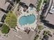 A lovely view of a community pool with lounge chairs, tables, and manicured landscaping at 29606 N Tatum Blvd # 174, Cave Creek, AZ 85331