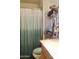 Bathroom featuring a single sink vanity, shower-tub combo with curtain, and storage rack at 3001 W Shaw Butte Dr, Phoenix, AZ 85029