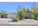 Quaint single-story home featuring a two-car garage and low-maintenance desert landscaping in front at 3001 W Shaw Butte Dr, Phoenix, AZ 85029