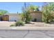 Street view of single-story home featuring a two-car garage and low-maintenance desert landscaping at 3001 W Shaw Butte Dr, Phoenix, AZ 85029