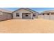 A view of the back of the home with a patio, windows, and a yard ready for landscaping at 31619 N Shady Pasture Ln, San Tan Valley, AZ 85143