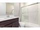 Modern bathroom with quartz countertop, dark wood cabinetry and a marble-look shower stall with glass doors at 31619 N Shady Pasture Ln, San Tan Valley, AZ 85143