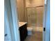 Bright bathroom with a glass-door shower and vanity with a dark base at 31619 N Shady Pasture Ln, San Tan Valley, AZ 85143