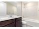 Modern bathroom featuring a tub, shower, and a dark vanity with white countertops at 31619 N Shady Pasture Ln, San Tan Valley, AZ 85143