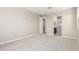 A bright, carpeted bedroom provides entry to the en suite bathroom and walk-in closet at 31619 N Shady Pasture Ln, San Tan Valley, AZ 85143