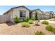 Charming single-story home with a gravel yard, and lush landscaping featuring green plants enhancing curb appeal at 31619 N Shady Pasture Ln, San Tan Valley, AZ 85143