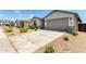 Charming single-story home featuring a well-maintained lawn, neutral stucco facade, and attached two-car garage at 31619 N Shady Pasture Ln, San Tan Valley, AZ 85143