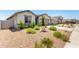 Inviting single-story home with a gravel yard, and lush landscaping with green plants adding curb appeal at 31619 N Shady Pasture Ln, San Tan Valley, AZ 85143