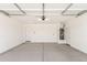 An empty two car garage with a water heater and white walls ready to be filled with possibilities at 31619 N Shady Pasture Ln, San Tan Valley, AZ 85143