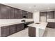 Modern kitchen features stainless steel appliances, an island, and sleek, dark cabinets at 31619 N Shady Pasture Ln, San Tan Valley, AZ 85143