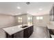 A large kitchen island opens up to the living area with sliding glass doors at 31619 N Shady Pasture Ln, San Tan Valley, AZ 85143
