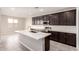 Modern kitchen showcasing a central island, sleek countertops, stainless steel appliances, and ample cabinet space at 31619 N Shady Pasture Ln, San Tan Valley, AZ 85143