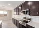 Kitchen includes stainless steel appliances, dark cabinets, and white quartz countertops at 31619 N Shady Pasture Ln, San Tan Valley, AZ 85143