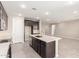 Kitchen island boasts a sink and dishwasher with dark cabinets and an open floorplan at 31619 N Shady Pasture Ln, San Tan Valley, AZ 85143