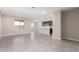 Bright living space with tile floors, neutral colors flowing to a kitchen with dark cabinets and stainless appliances at 31619 N Shady Pasture Ln, San Tan Valley, AZ 85143