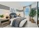 This bedroom includes carpet flooring, a queen bed, nightstands, and a decorative plant at 3335 S Lily Ave, Mesa, AZ 85212