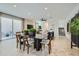 Modern dining area boasts a large table and seamlessly flows into the living room, creating an inviting space at 3335 S Lily Ave, Mesa, AZ 85212