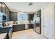 Stylish kitchen featuring stainless steel appliances, dark cabinets, and a bright window at 3335 S Lily Ave, Mesa, AZ 85212