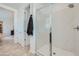 Shower showcasing glass doors, marble tiling, and a shower head. The bathroom is bright with tile flooring at 3335 S Lily Ave, Mesa, AZ 85212