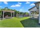 Lush backyard featuring a pool, pergola and patio at 3415 E Arabian Dr, Gilbert, AZ 85296