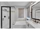 Modern bathroom with sleek glass shower, soaking tub, and elegant vanity at 3415 E Arabian Dr, Gilbert, AZ 85296