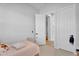 Bright bedroom with neutral tones featuring a twin bed and access to other rooms at 3415 E Arabian Dr, Gilbert, AZ 85296