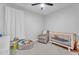 bedroom with a crib, accent chair, and play area at 3415 E Arabian Dr, Gilbert, AZ 85296